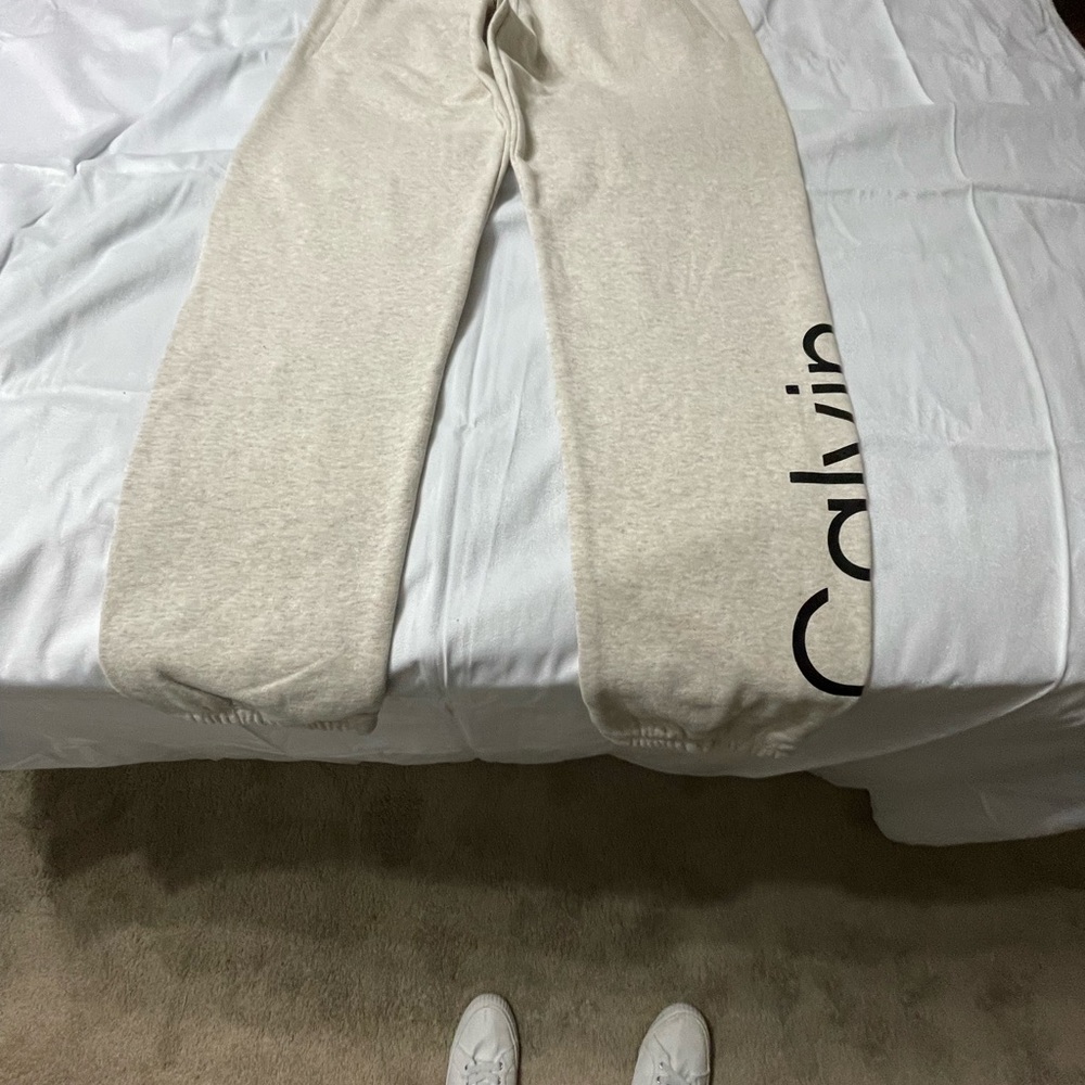 Brand NWT Calvin Klein beige w/black lettering size large. NBW